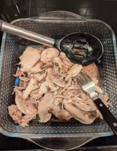 Reserved chicken meat, continuing to cool in the same pan.