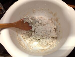 The bowl showing a very wet dough or stiff batter consistency