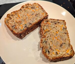 Two slices of fresh bread, sitting on a small side plate.