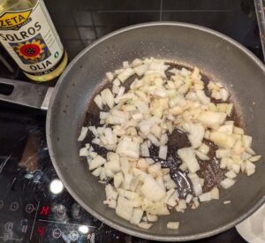 Chopped onion just added into the bacon pan