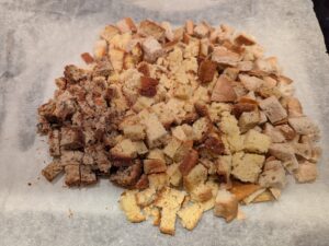 Cubed bread on a piece of baking paper.
