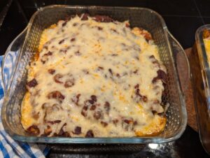 A finished pan of cheese-topped enchiladas.