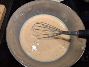 The egg, milk, and starch mixture in the bowl.
