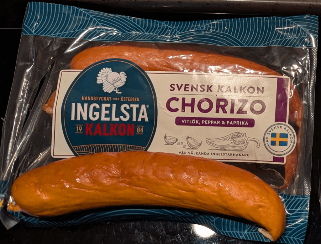 A package of 3 links of Ingelsta brand cooked turkey chorizo sausages, with one sausage sitting on top
