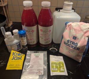 A collection of winemaking ingredients plus fermentation jug
