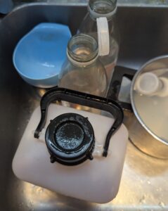 The jug still down in the sink but with the lid on it now
