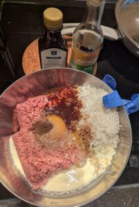 Unmixed meat ingredients in the bowl ready to be mixed