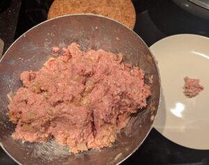 A very wet meatloaf mixture in the mixing bowl