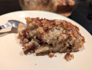 A finished piece of warm cake on a small plate.