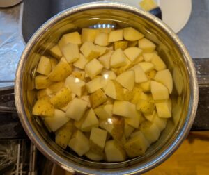 A pot of cubed potatoes in water