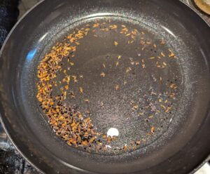 Spice seeds frying in oil