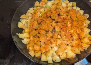 Half-cooked potatoes sprinkled with the other seasonings