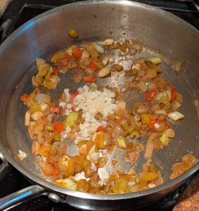 Garlic added to the pan of softened vegetables