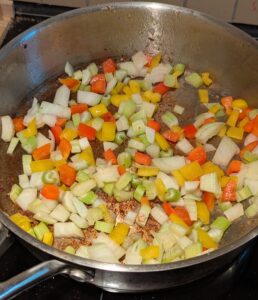 Onion, celery and red & yellow peppers added into the same pan