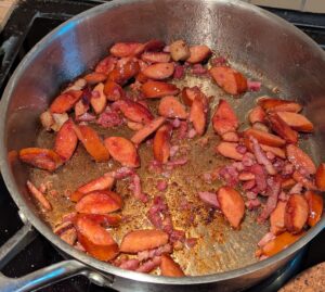 Browned sausage and bacon in the pan