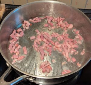 Pan with frying chopped bacon