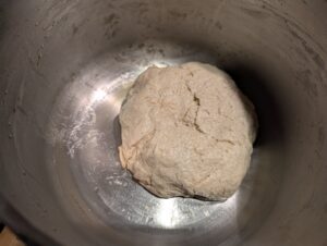 Oil-coated ball of unraised dough inside the now also lightly oiled bowl