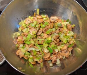 Leeks added in pan with mushrooms