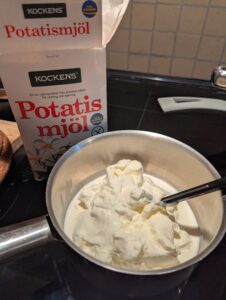 Small pan of crรจme fraiche with a box of potato starch behind it