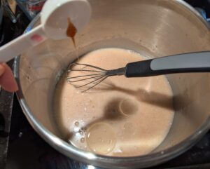 Wet ingredients being combined in the mixing bowl