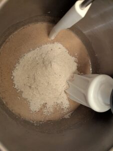 Flour mixture added into the wet ingredients before turning on a stand mixer with dough working attachments